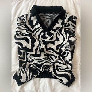 This is a fashion nova zebra print sweater. That your not gonna wanna miss!